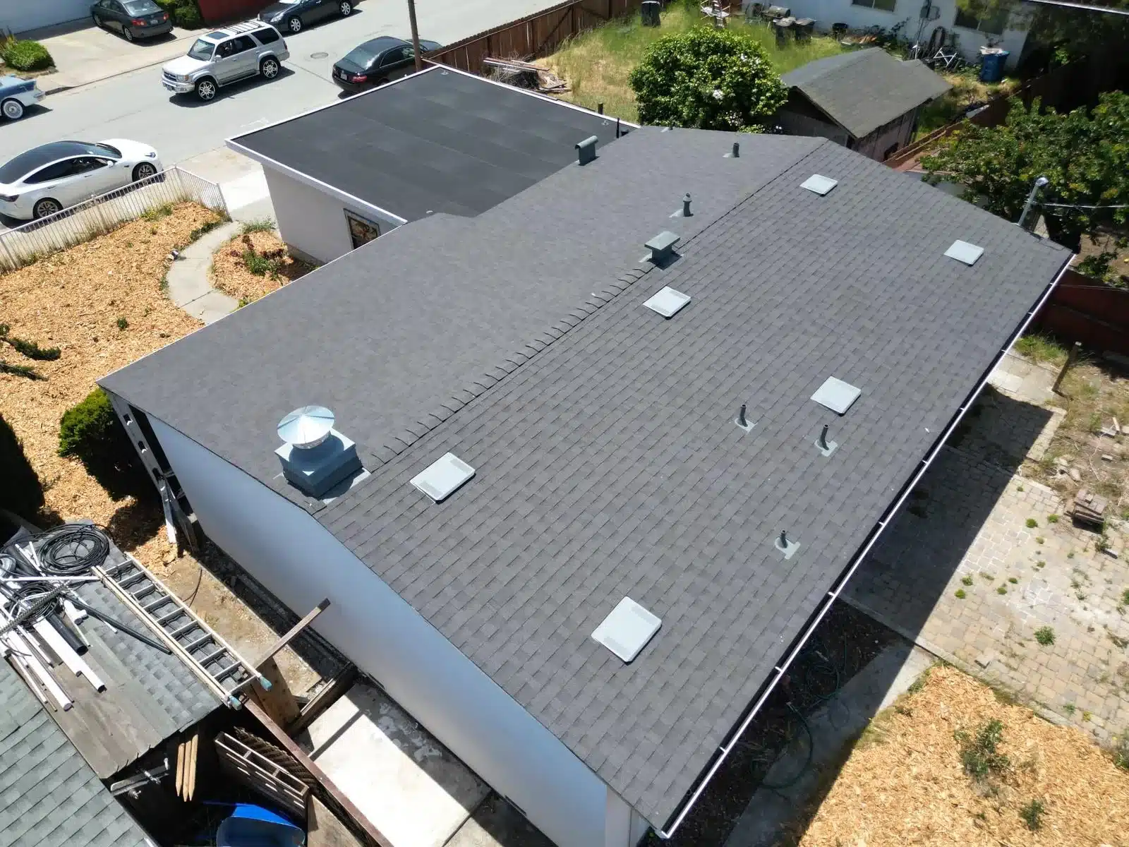Completed shingle roof with new vents and skylights at Maxine Ave, San Mateo