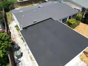 Finished roof on Maxine Ave, San Mateo, showing the shingled slopes meeting the smooth low-slope section