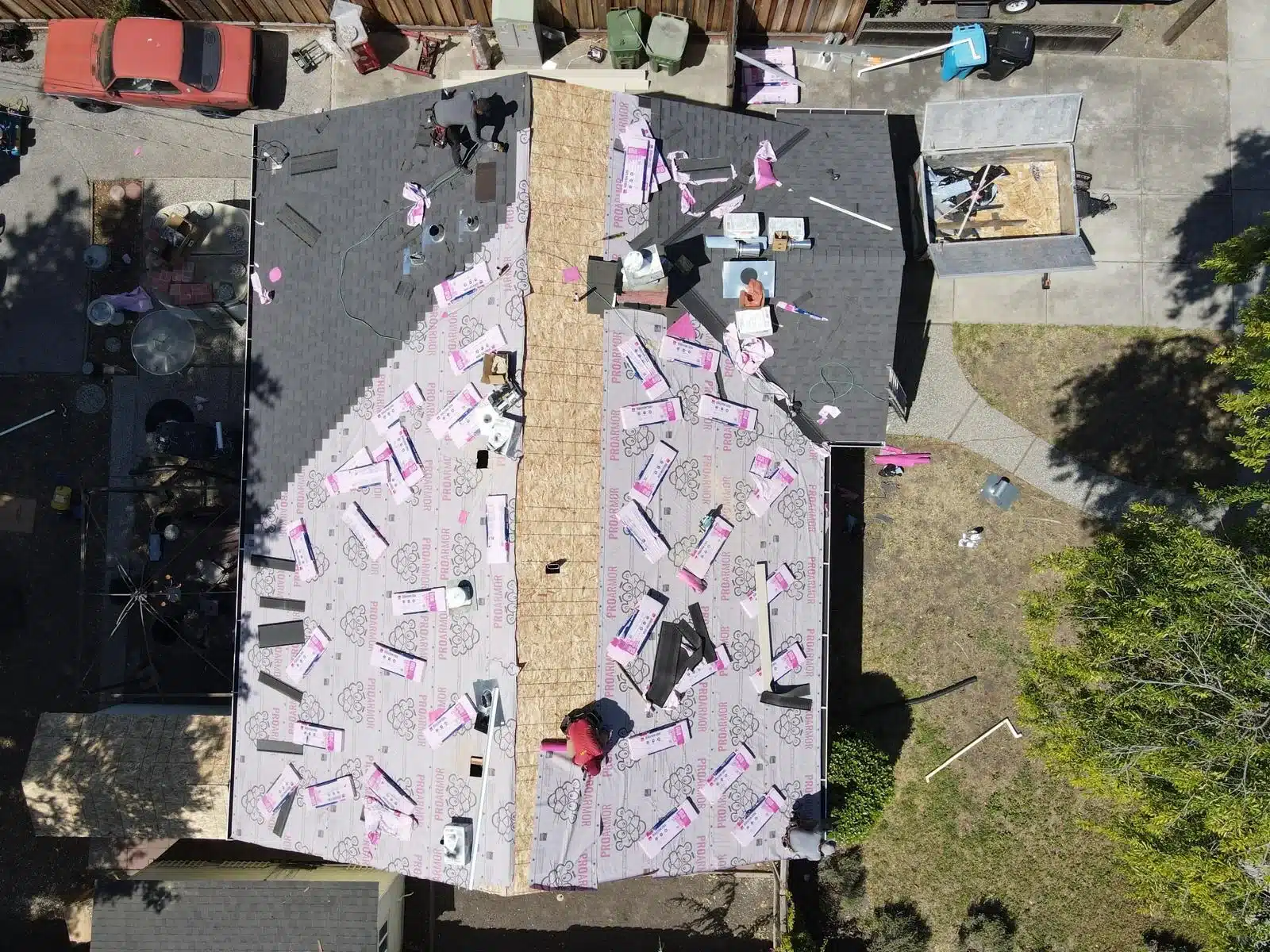 Synthetic underlayment rolled out with the first courses of shingles going on at 2168 Forbes Avenue, Santa Clara CA