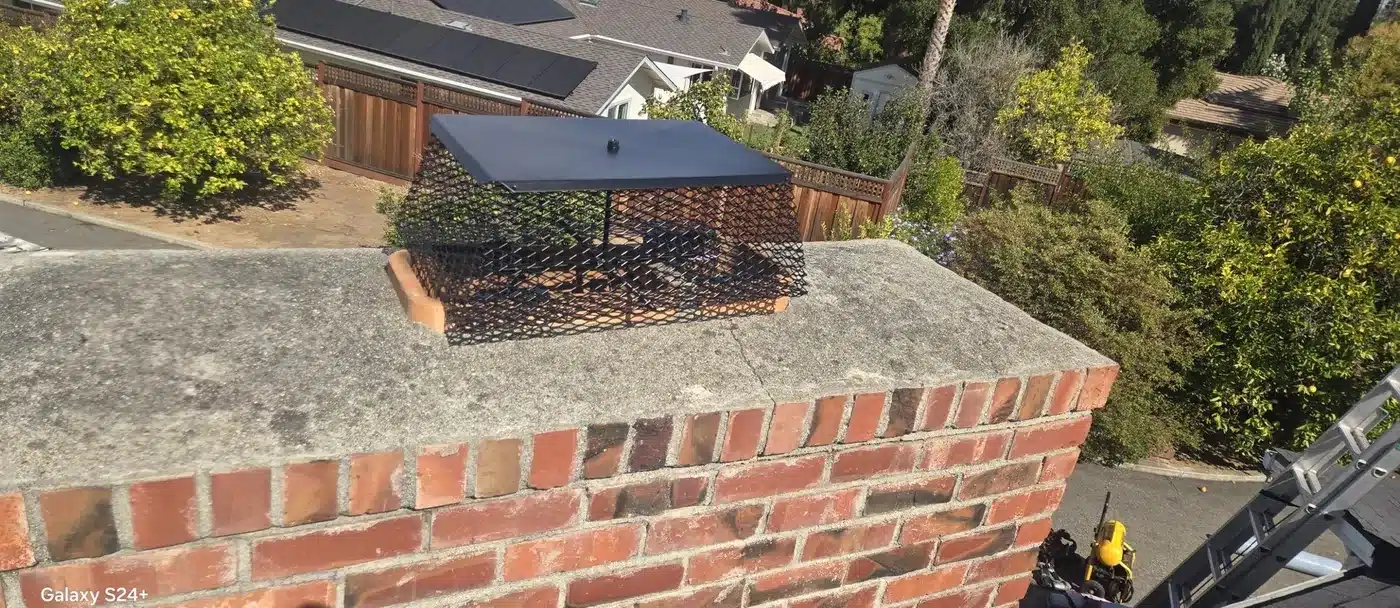 New chimney cap and flashing on the brick chimney after the roof replacement in Saratoga, CA