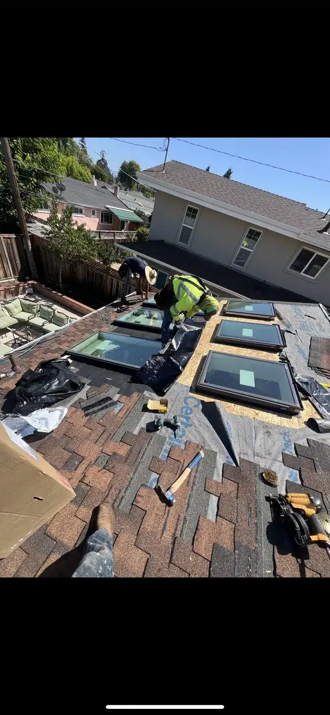 Roofer installing architectural shingles on Lansdale Avenue in Cupertino