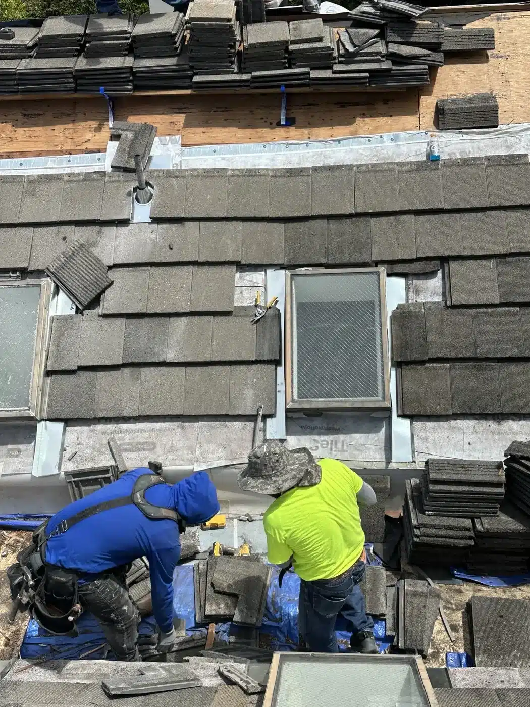 Crew reflashing a skylight during the tile re-lay on a Vallejo HOA roof