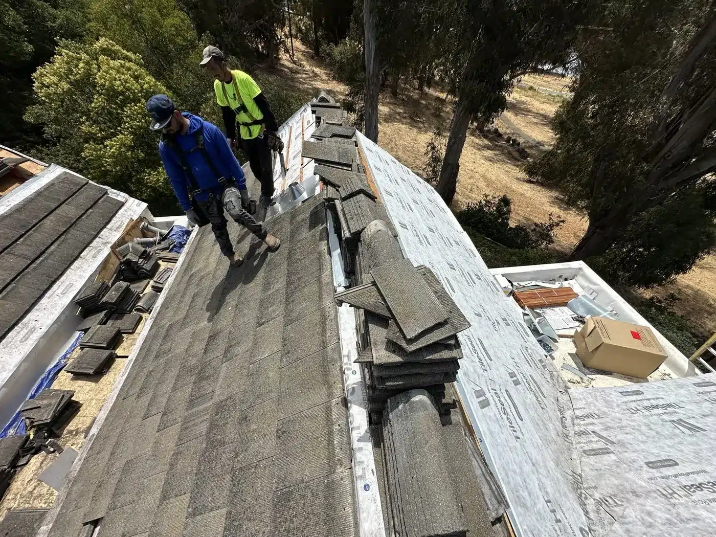Roofing crew re-laying concrete tile on a Vallejo townhome roof