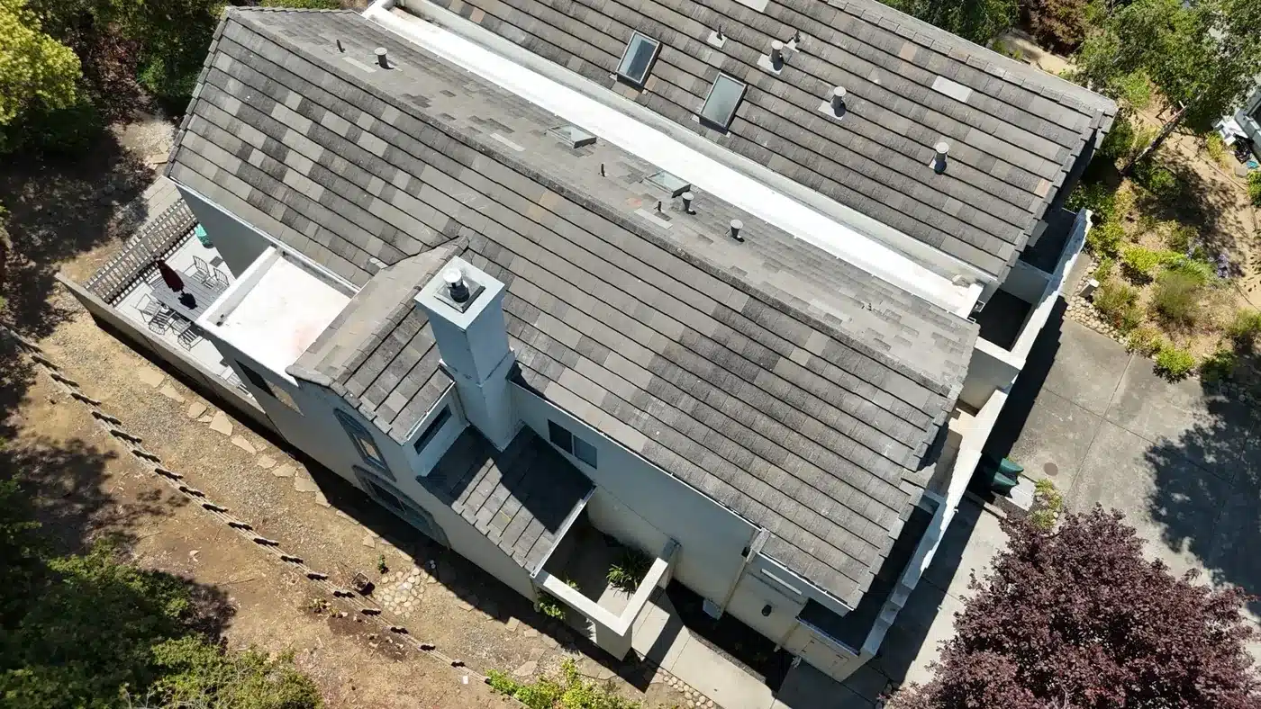 Finished re-laid concrete tile roof with rebuilt white flat section, Vallejo HOA, aerial view