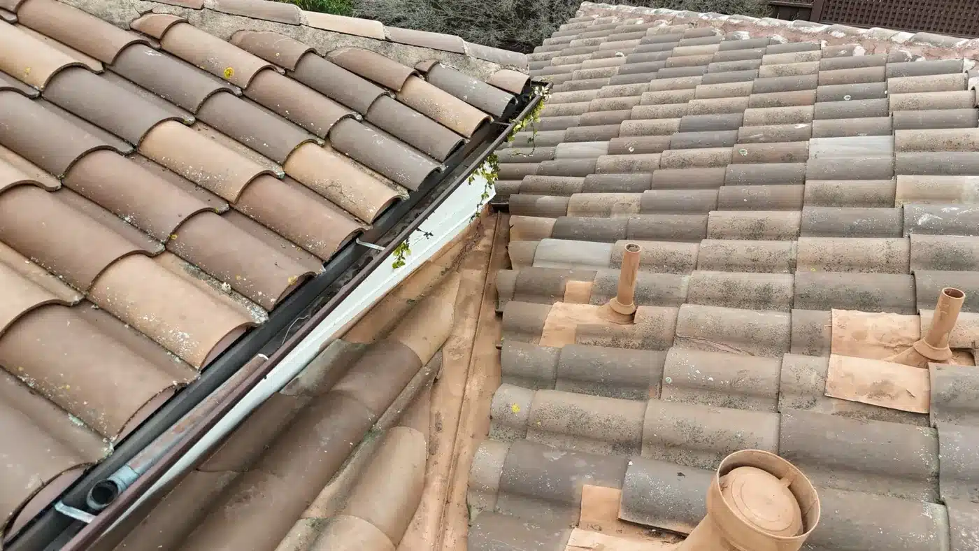 Relaid clay tile and painted pipe flashings beside the gutter after the Benicia repair