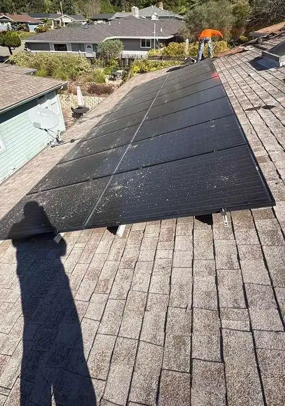 Original 20-year-old asphalt shingle roof with solar panels in El Sobrante before tear-off