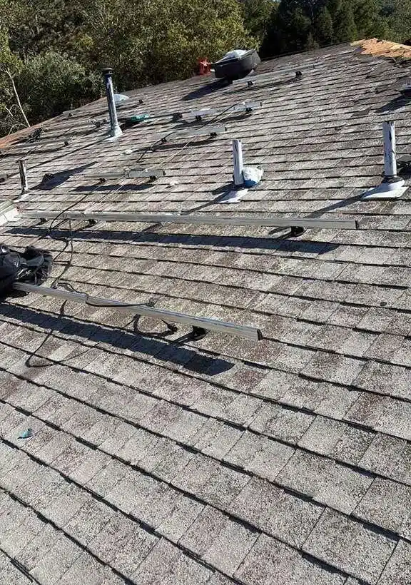 Worn original shingles and solar mounts left after the panels came off an El Sobrante roof