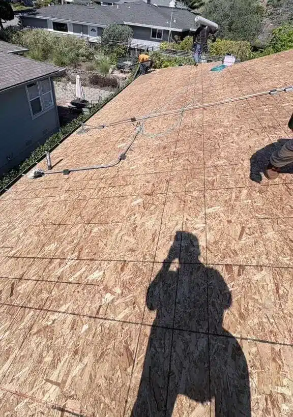 New OSB sheathing laid over the roof deck after tear-off in El Sobrante