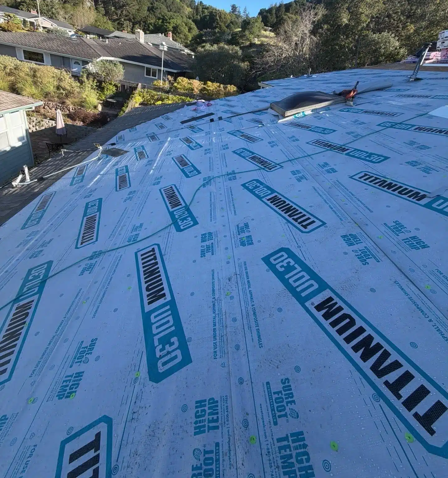 Synthetic underlayment covering the new deck before shingles on the El Sobrante roof