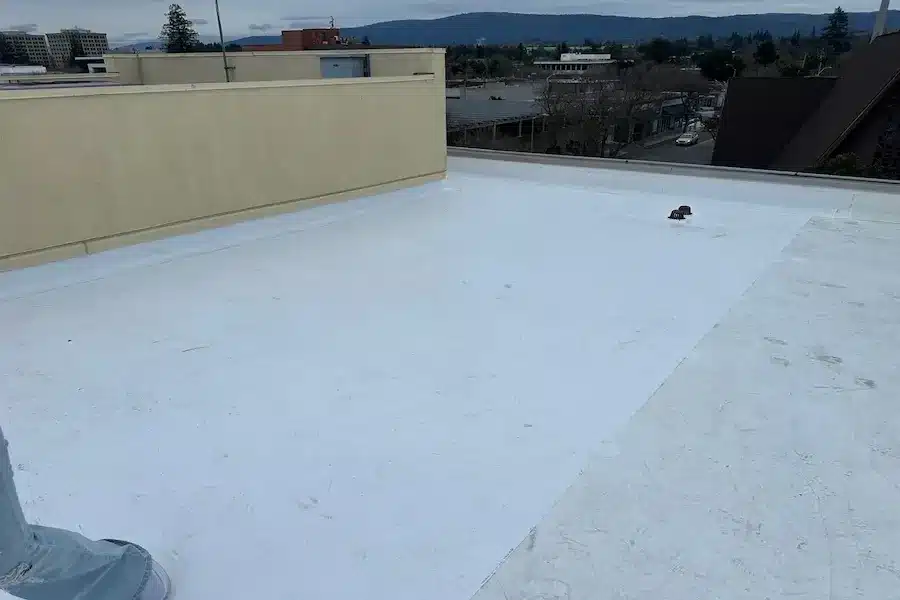 Finished white single-ply membrane on a commercial building roof overlooking downtown Palo Alto