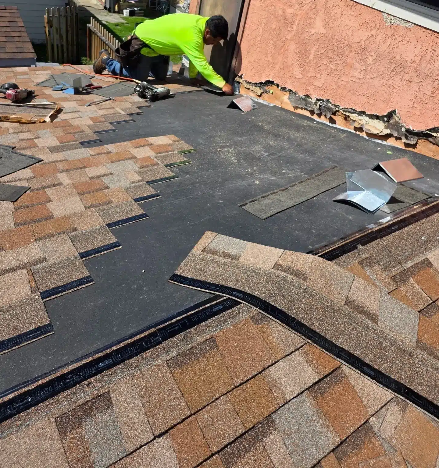 Self-adhered underlayment along the stucco wall as new shingles go on in Berkeley