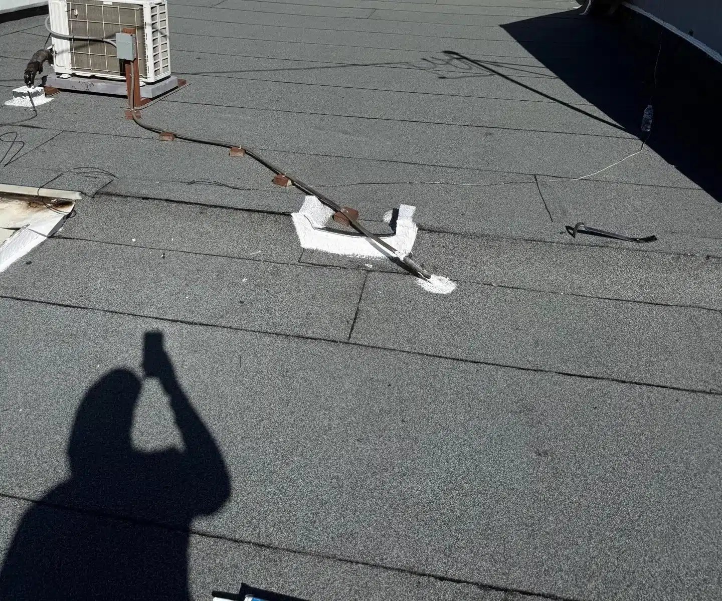 Completed torch-down roofing around a rooftop HVAC curb on an auto shop in Rodeo CA