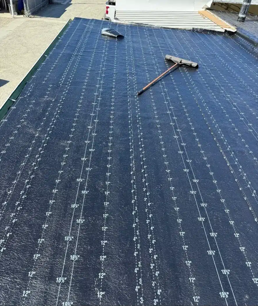 New base sheet fastened in rows across the low-slope roof during a torch-down reroof in Rodeo CA