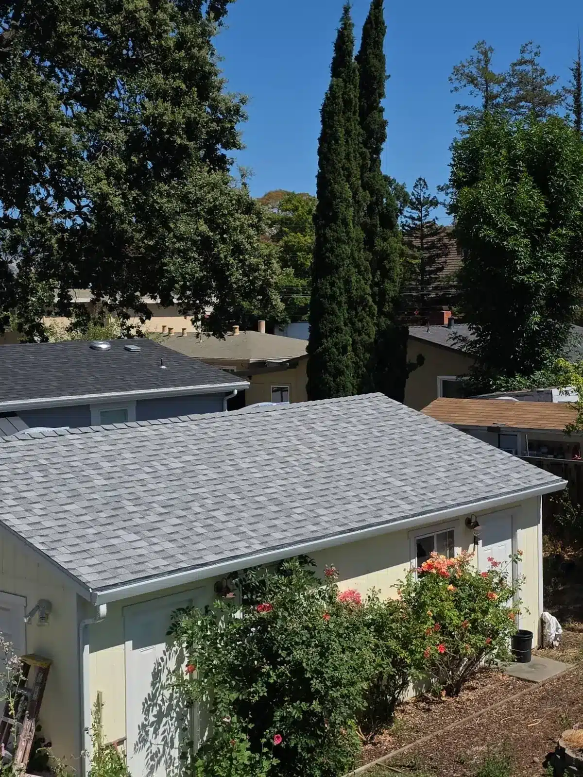 Backyard shed reroofed with matching gray shingles as part of the Pleasant Hill roof replacement