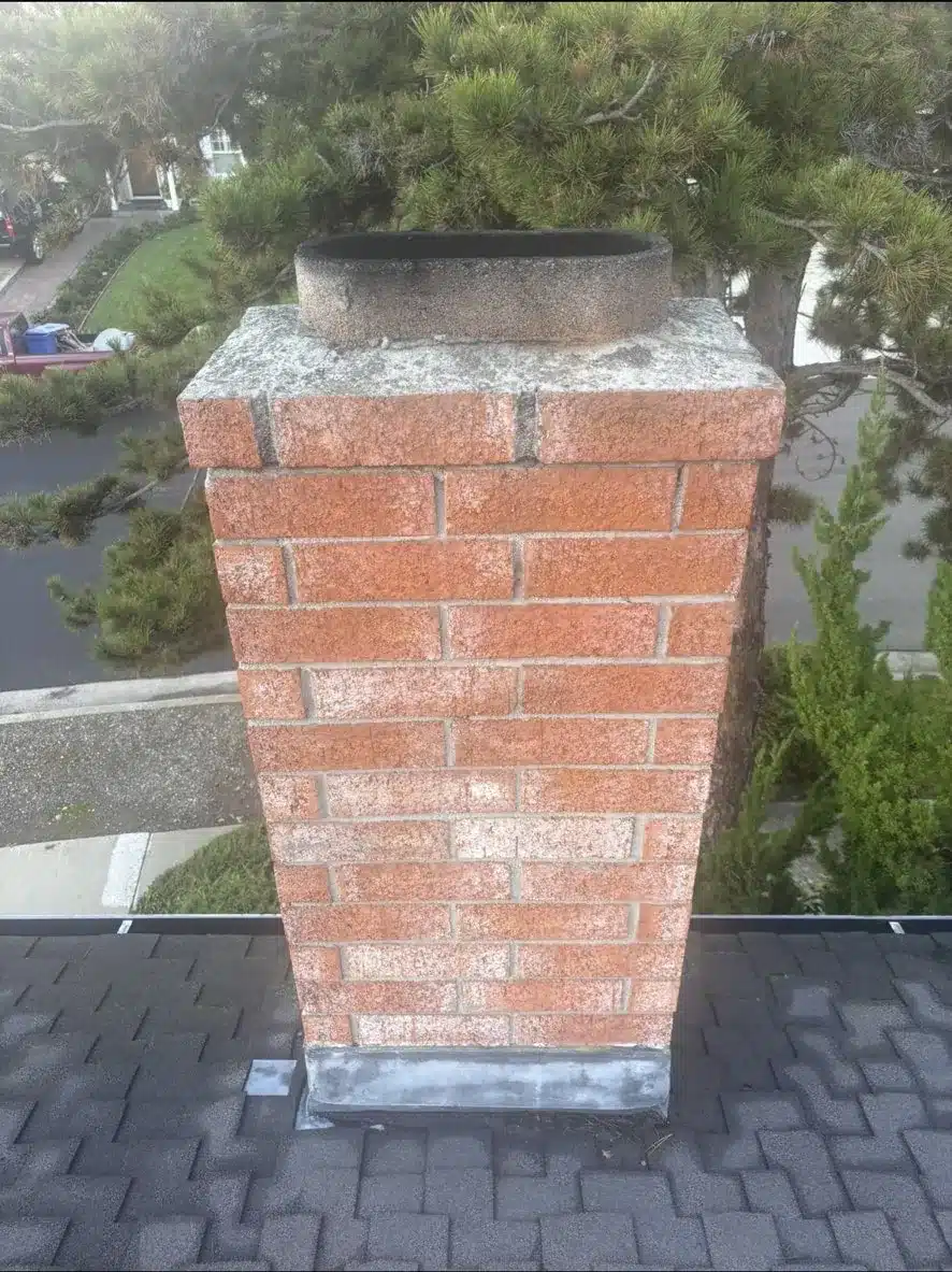 Brick chimney with an open flue and no spark arrestor before the San Jose reroof