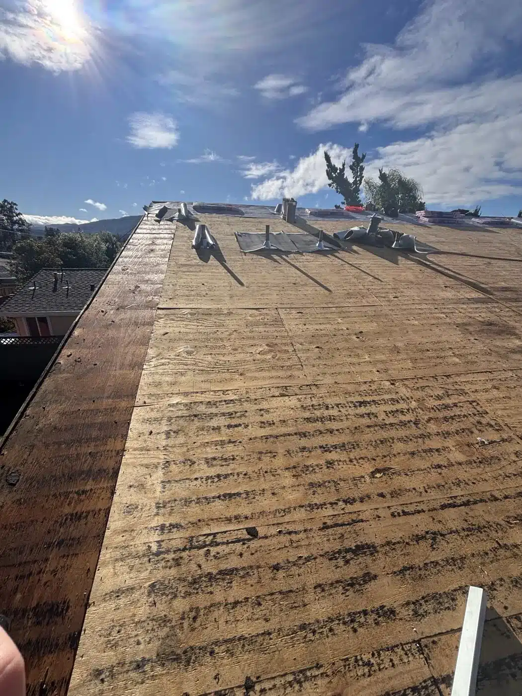 Board roof deck exposed after the old shingles were torn off in San Jose