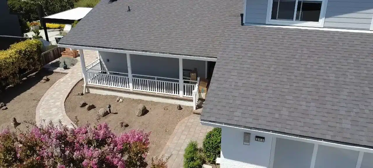 Completed dark grey architectural shingle roof and porch on the San Rafael home after replacement