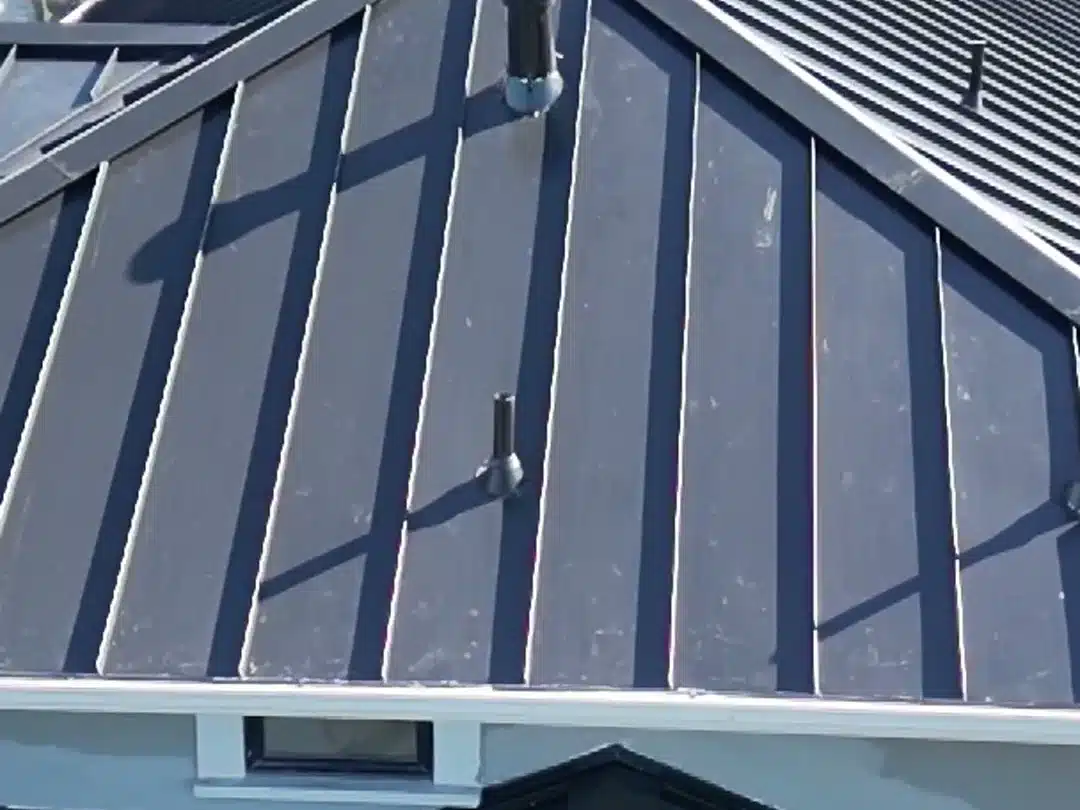 Locked standing-seam metal panels running to the eave on a Bay Area home