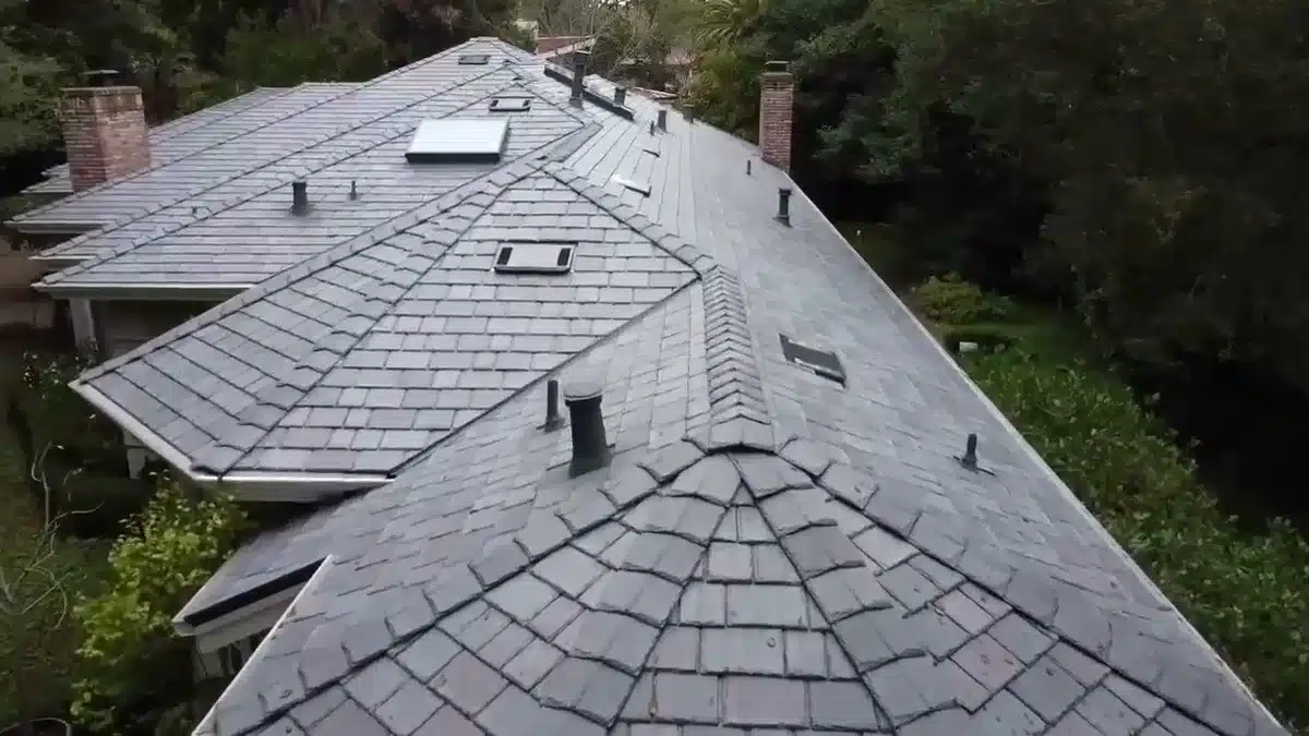 Aerial view of a finished synthetic slate roof with hip caps on a Bay Area home, installed by Lifetime Roofing