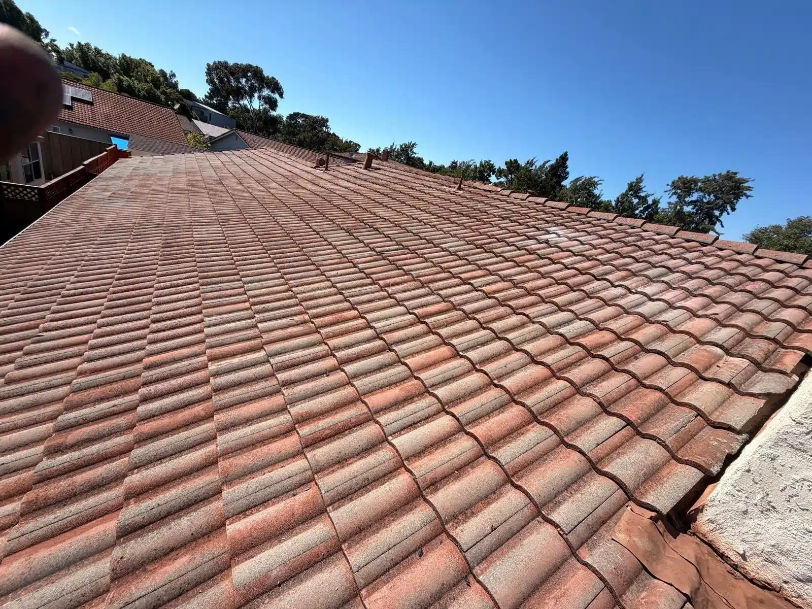 Reset concrete tile field running down to a hip on the finished San Mateo roof