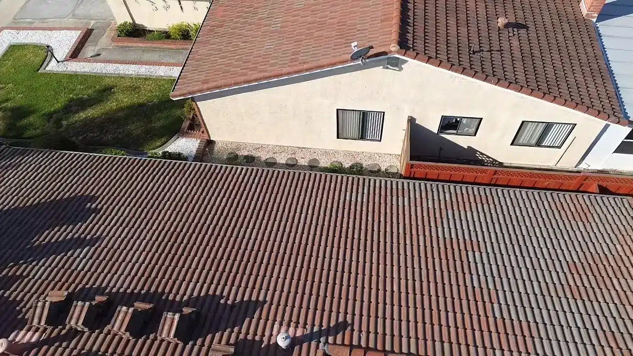 Aerial view of the original concrete tile roof on a San Mateo home as the tile reset began