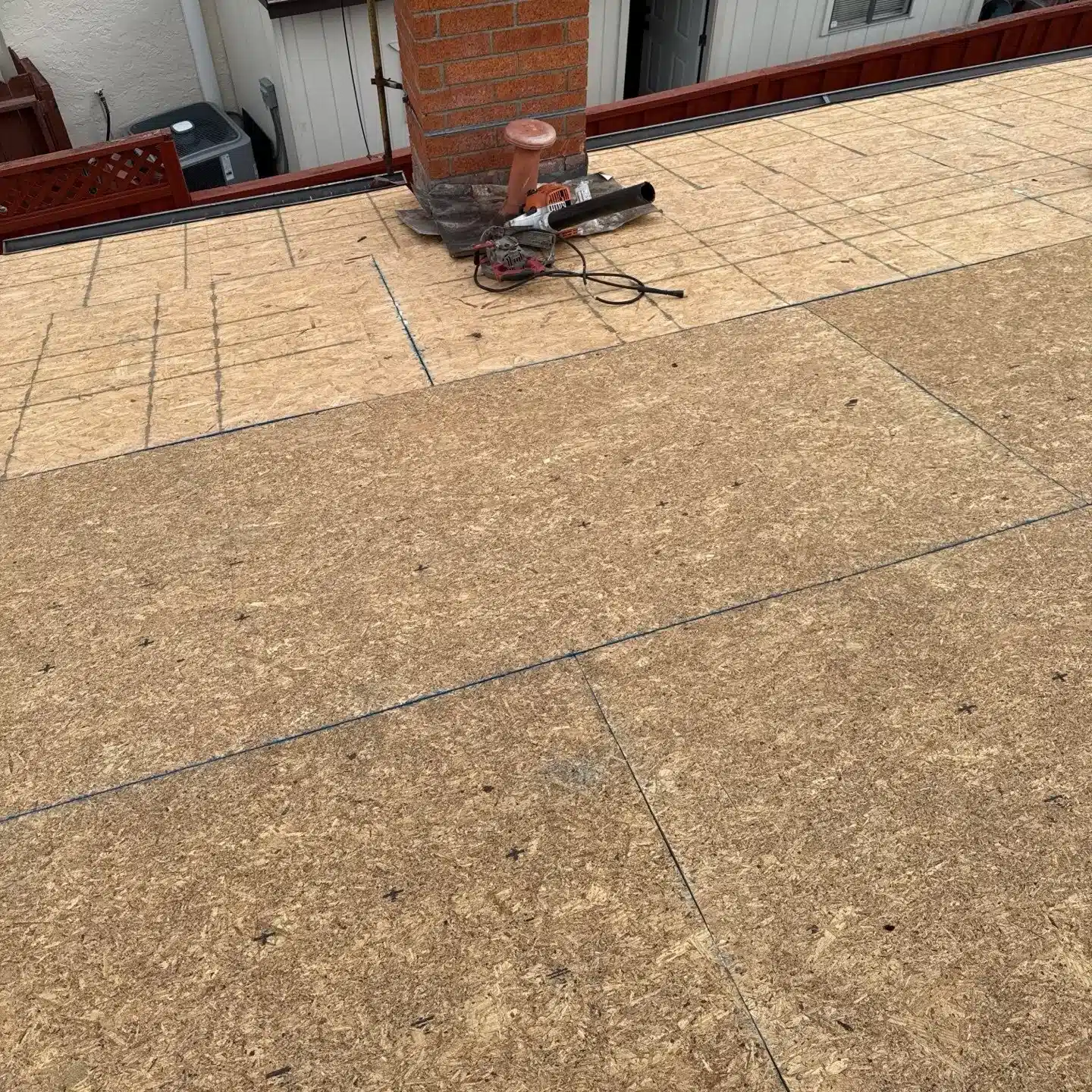 New plywood deck sheathed over the old spaced boards on a San Mateo tile roof