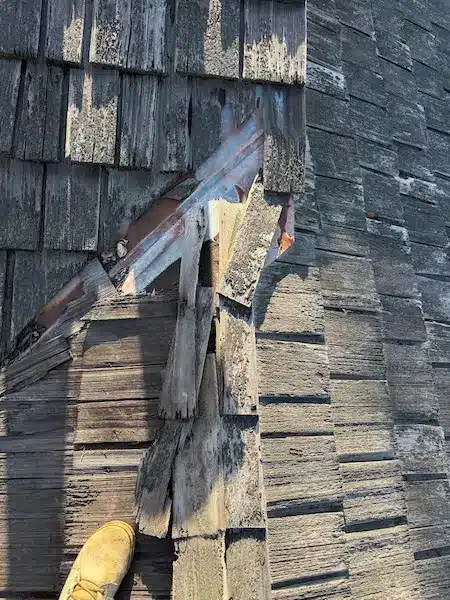 Weathered wood shake roof with a failed metal valley and rotted shakes before replacement on a house in Campbell CA
